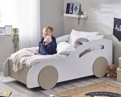 Child Sitting in Atlantis Toddler Car Bed - White & Taupe - Bedroom Setting